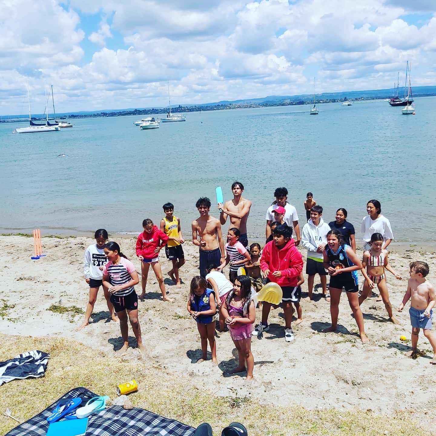 Te Maru o Mauao whānau together on the beach in Tauranga Moana