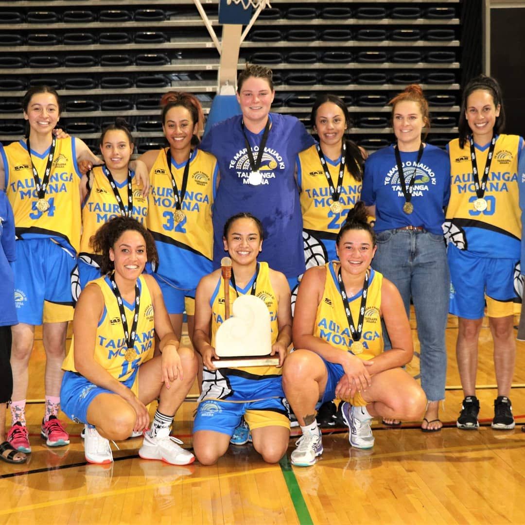 A senior women's team with the trophy